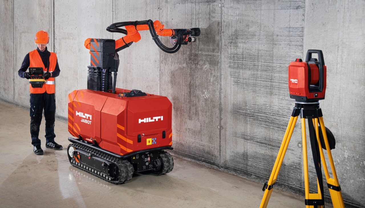 Concrete ceiling and construction robot drilling on a jobsite.